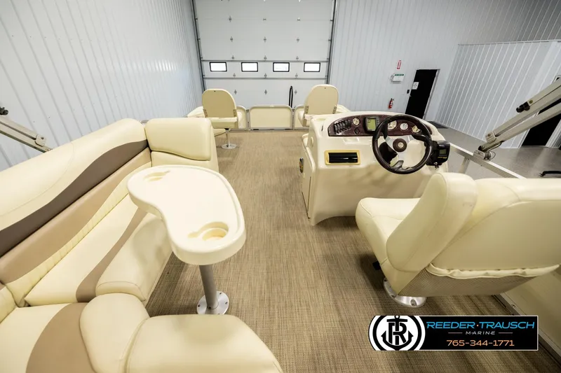 Slide: The Image of Interior of 2008 Bennington 2050 FSI boat with beige seating and steering console. - 17