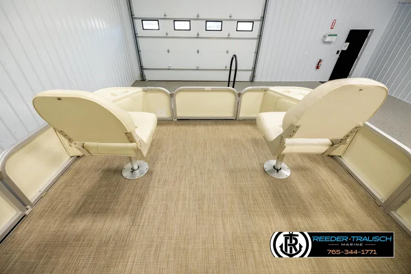 Slide: The Image of 2008 Bennington 2050 FSI boat interior with two cream seats in a garage setting. - 18