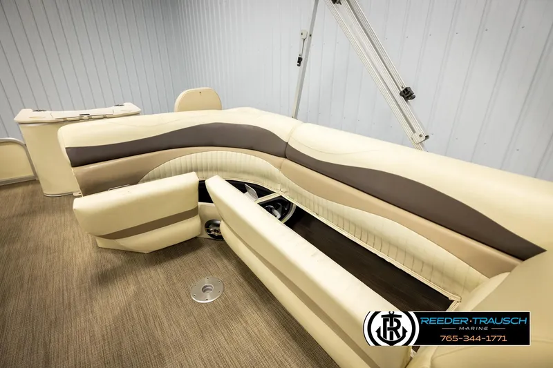 Slide: The Image of 2008 Bennington 2050 FSI boat interior with beige and brown seating, Reeder-Trausch Marine logo. - 21