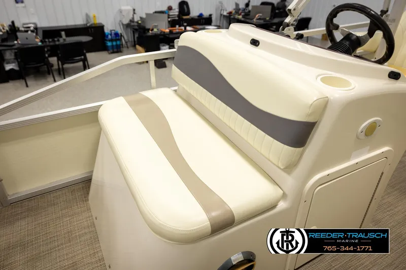Slide: The Image of 2008 Bennington 2050 FSI boat interior with beige and gray seating. - 22