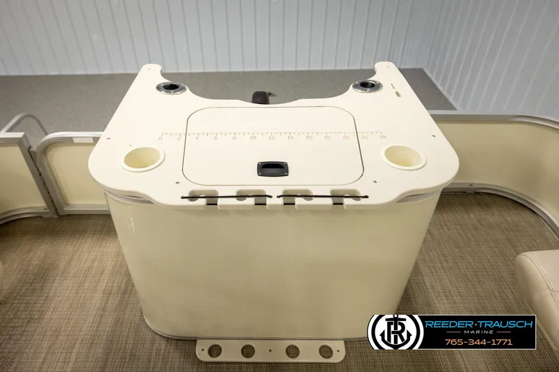 Slide: The Image of 2008 Bennington 2050 FSI boat interior with beige console and cup holders. - 24