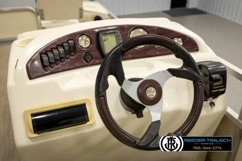Slide: The Image of Steering console of a 2008 Bennington 2050 FSI boat with control panel and gauges. - 26