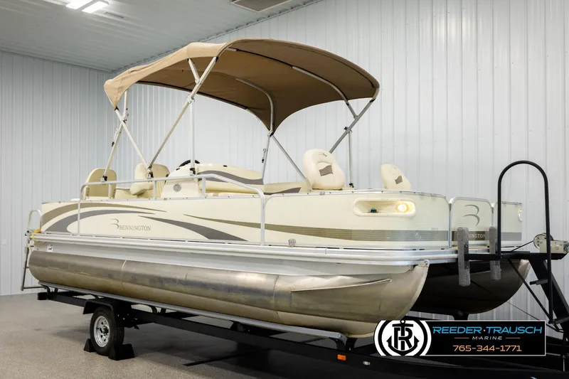 Slide: The Image of 2008 Bennington 2050 FSI pontoon boat with canopy on trailer in indoor showroom. - 3