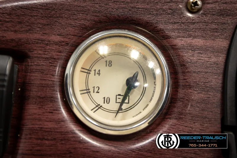 Slide: The Image of Close-up of a 2008 Bennington 2050 FSI fuel gauge on a wooden dashboard. - 30