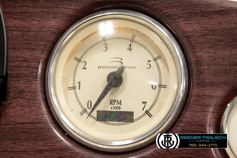 Slide: The Image of Close-up of a 2008 Bennington 2050 FSI RPM gauge on a wooden dashboard. - 32
