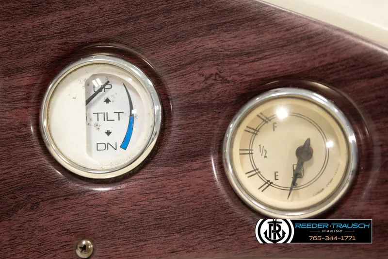 Slide: The Image of Dashboard gauges of a 2008 Bennington 2050 FSI boat, featuring tilt and fuel indicators. - 33