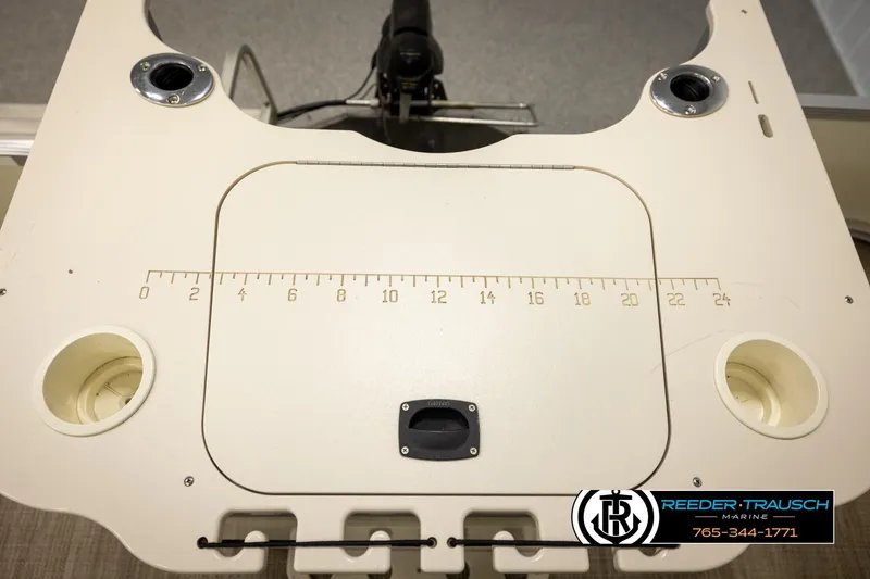 Slide: The Image of 2008 Bennington 2050 FSI boat console with measurement markings and cup holders. - 38