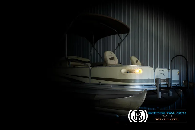 Slide: The Image of 2008 Bennington 2050 FSI pontoon boat in dimly lit storage facility. - 4