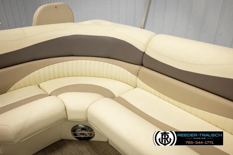 Slide: The Image of 2008 Bennington 2050 FSI boat interior with beige and gray seating, Reeder-Trausch Marine logo. - 40