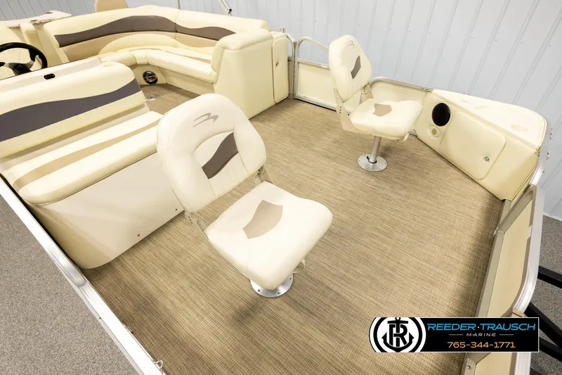 Slide: The Image of 2008 Bennington 2050 FSI boat interior with beige seating and carpet flooring. - 9