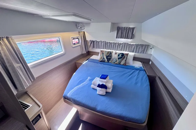 Slide: The Image of Luxurious cabin interior of 2024 Lagoon 42 catamaran with cozy bed and ocean view. - 18
