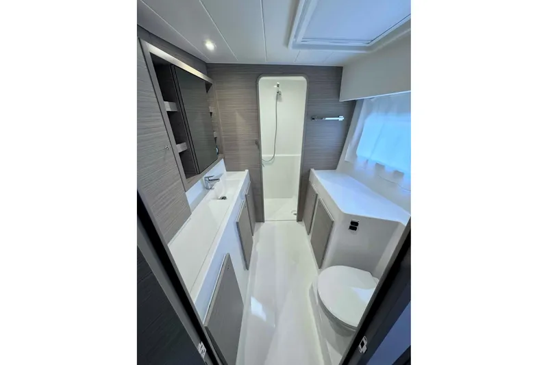Slide: The Image of Modern bathroom interior of 2024 Lagoon 42 yacht, featuring sleek design and ample storage. - 22