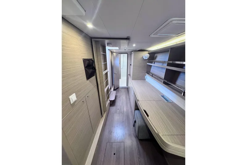 Slide: The Image of 2024 Lagoon 42 interior with modern wood finish and sleek design. - 23