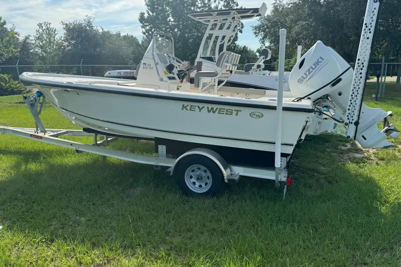 Slide: The Image of 2024 Key West 188 Bay Reef boat on trailer with Suzuki outboard motor. - 3