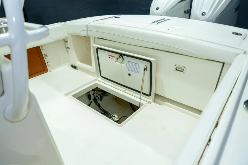 Slide: The Image of 2023 Regulator 28 boat interior showing bilge area with wiring and pump system. - 12