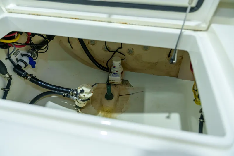 Slide: The Image of 2023 Regulator 28 boat interior with white seating and storage compartment. - 13