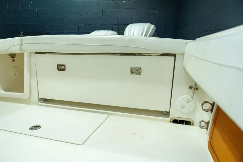 Slide: The Image of 2023 Regulator 28 boat interior with white seating and dual engines. - 14