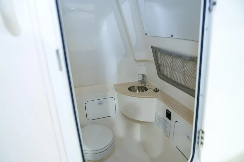 Slide: The Image of 2023 Regulator 28 boat interior with seating and console, displayed indoors. - 22