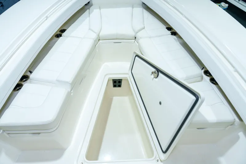 Slide: The Image of 2023 Regulator 28 boat interior with white seating and cup holders. - 29