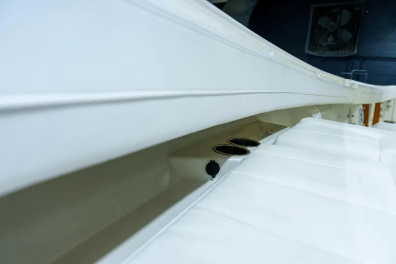 Slide: The Image of 2023 Regulator 28 boat interior with open storage compartment and white seating. - 30