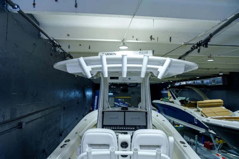 Slide: The Image of 2023 Regulator 28 boat interior detail with storage compartment and nautical decor. - 33