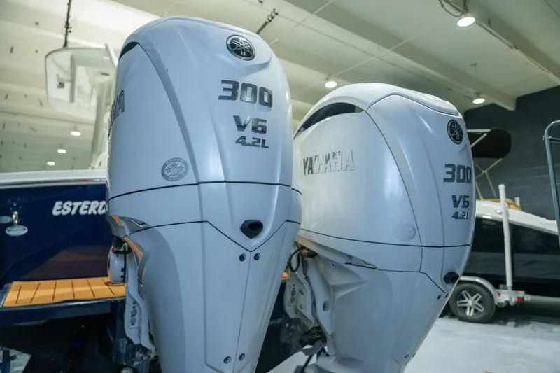 Slide: The Image of 2023 Regulator 28 boat in indoor storage, showcasing sleek blue hull design. - 5