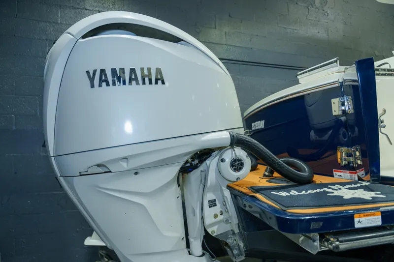 Slide: The Image of 2023 Regulator 28 boat with dual engines in a storage area. - 7