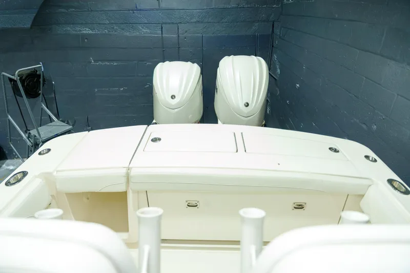 Slide: The Image of 2023 Regulator 28 boat interior with white cushioned seats and cup holder. - 8