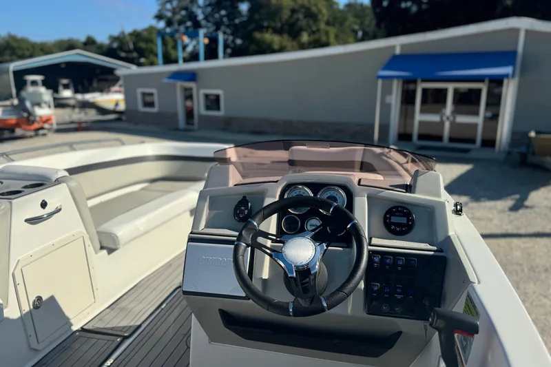 Slide: The Image of 2022 Starcraft SVX 191 OB boat interior with steering wheel and dashboard controls. - 6