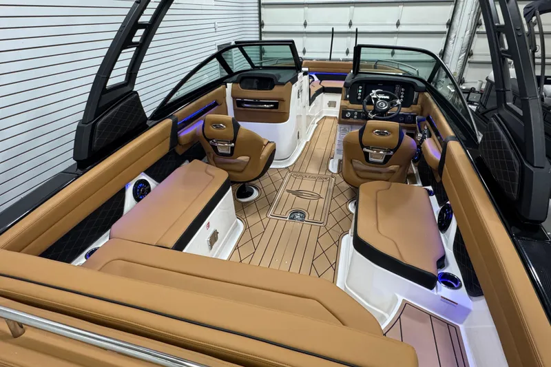Slide: The Image of Luxurious interior of 2026 Chaparral 6 SSX boat with tan seating and modern dashboard. - 13