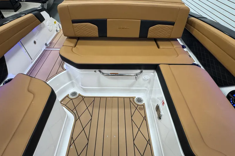 Slide: The Image of 2026 Chaparral 6 SSX boat interior with tan seating and teak-style flooring. - 15