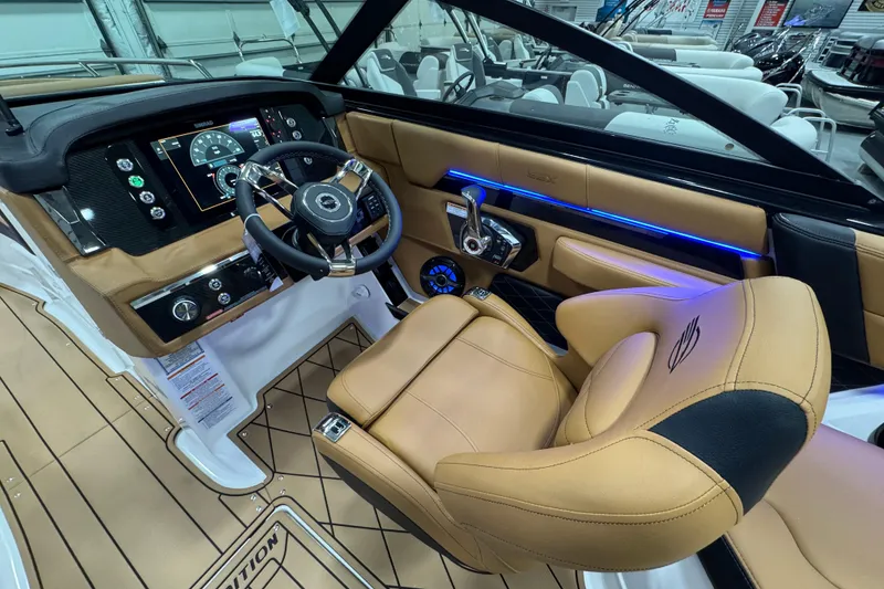 Slide: The Image of 2026 Chaparral 6 SSX boat interior with tan leather seats and modern dashboard. - 25