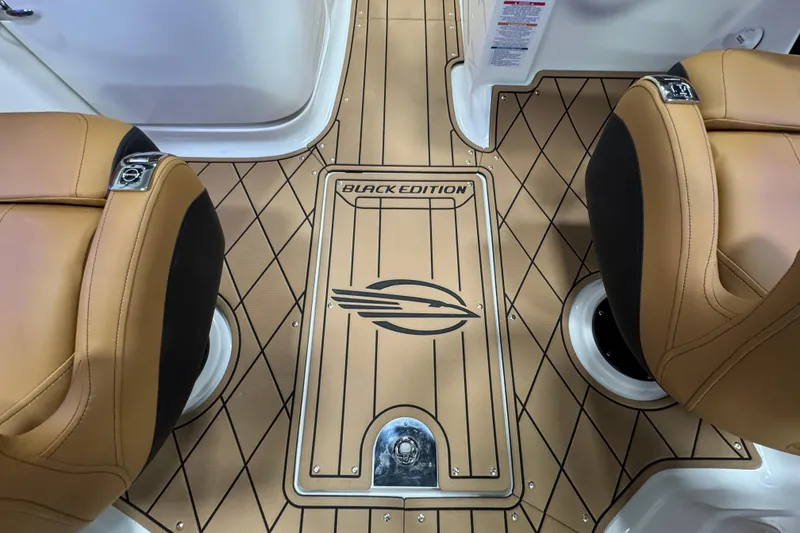 Slide: The Image of 2026 Chaparral 6 SSX Black Edition interior with tan seats and custom flooring. - 27