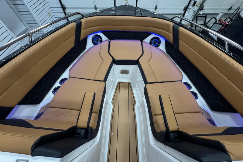 Slide: The Image of Luxurious interior of 2026 Chaparral 6 SSX boat with tan seating and blue lighting. - 31