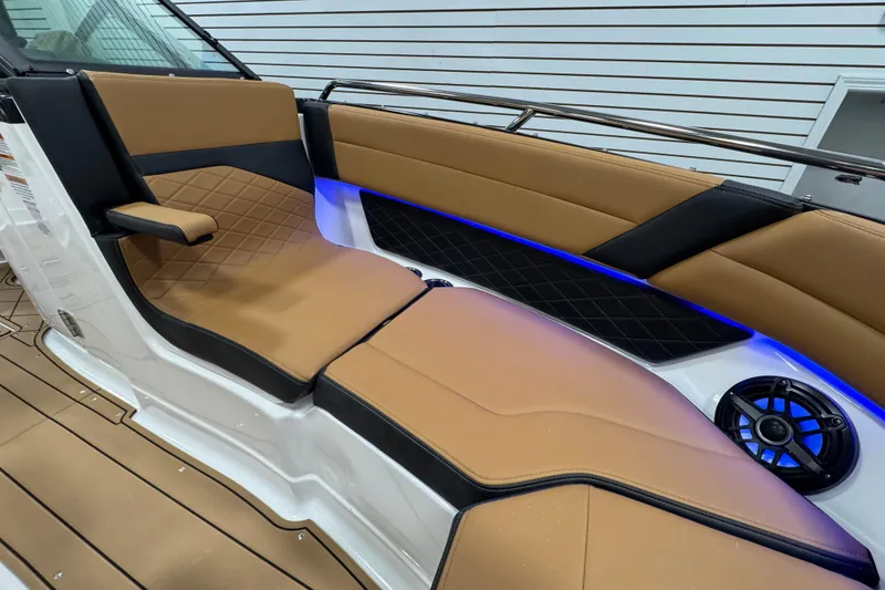 Slide: The Image of 2026 Chaparral 6 SSX boat interior with tan leather seats and blue LED lighting. - 34