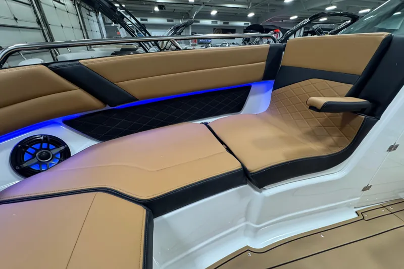 Slide: The Image of 2026 Chaparral 6 SSX boat interior with tan and black seating, blue LED lighting. - 35