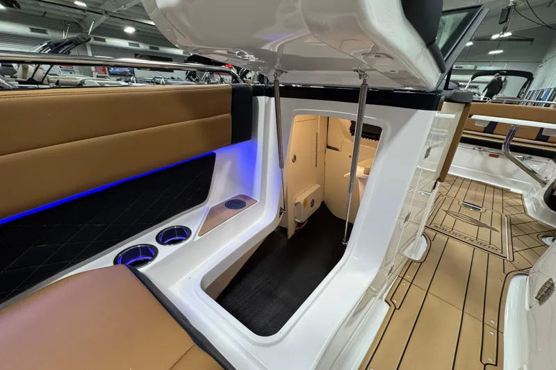 Slide: The Image of 2026 Chaparral 6 SSX boat interior with seating, cup holders, and cabin entrance. - 38