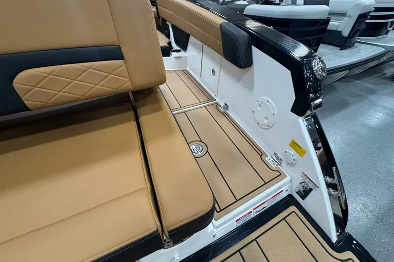 Slide: The Image of 2026 Chaparral 6 SSX boat interior with tan seating and sleek design. - 9
