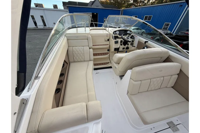 Slide: The Image of 2019 Regal 28 Express boat interior with beige seating and modern dashboard. - 10