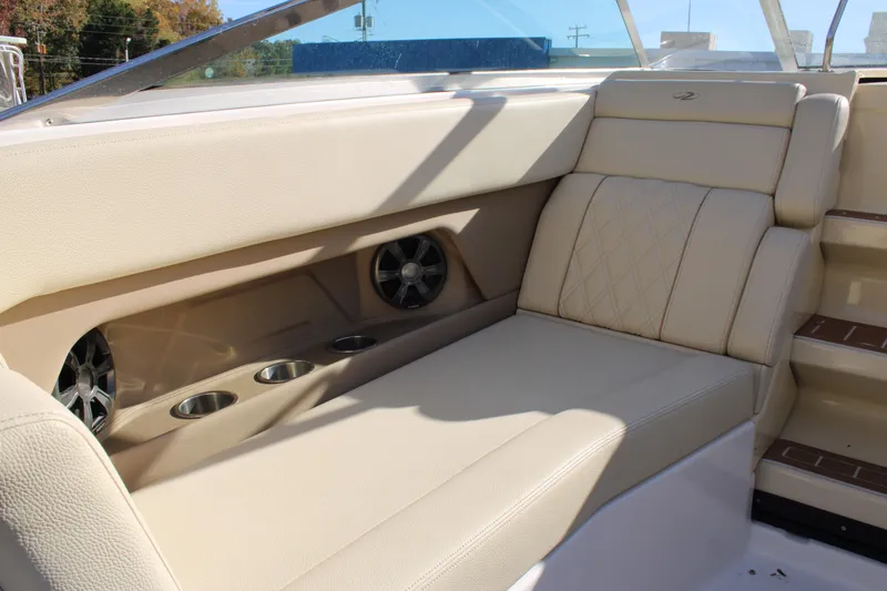 Slide: The Image of Luxurious seating on 2019 Regal 28 Express boat with cup holders and speakers. - 12