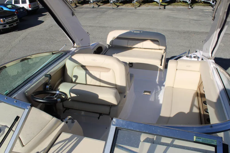 Slide: The Image of 2019 Regal 28 Express boat interior with beige seating and steering wheel. - 14
