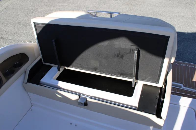 Slide: The Image of 2019 Regal 28 Express boat storage compartment with open lid, showcasing interior space. - 18