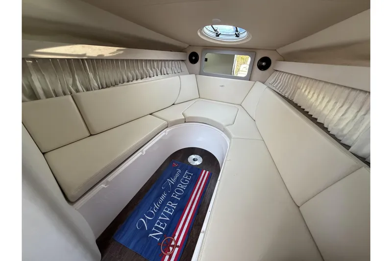 Slide: The Image of 2019 Regal 28 Express cabin interior with white seating and nautical decor. - 21