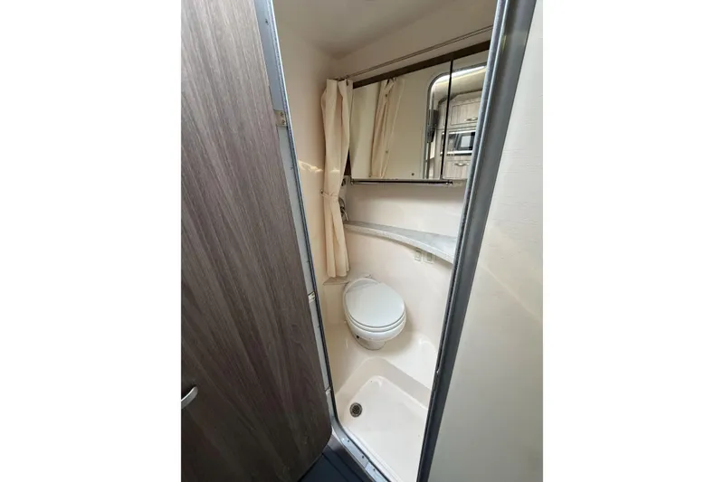 Slide: The Image of Compact bathroom in 2019 Regal 28 Express boat with toilet and shower. - 25