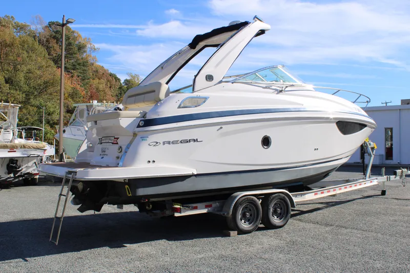 Slide: The Image of 2019 Regal 28 Express boat on trailer, parked outdoors. - 5
