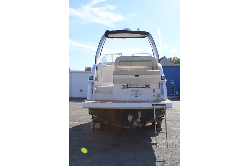 Slide: The Image of Rear view of 2019 Regal 28 Express boat on trailer in parking lot. - 6