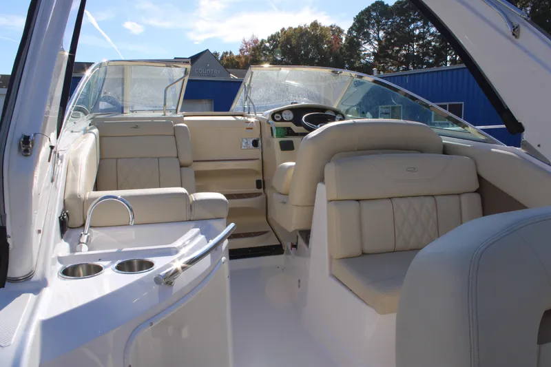 Slide: The Image of 2019 Regal 28 Express boat interior with beige seating and modern dashboard. - 9