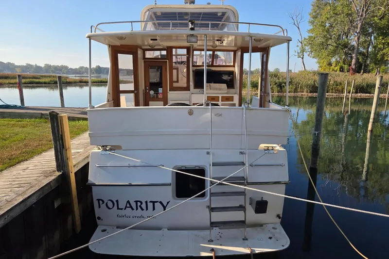 Slide: The Image of 1988 Novamarine 36 Heritage East Trawler docked at a serene waterfront location. - 2