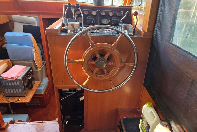 Slide: The Image of 1988 Novamarine 36 Heritage East Trawler helm with wooden wheel and control panel. - 5