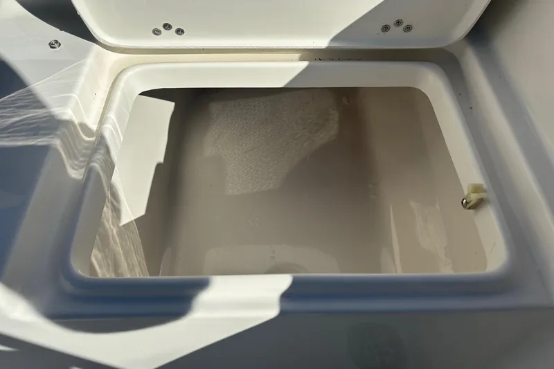 Slide: The Image of Open storage compartment on 2026 Key West 189 FS boat, showing interior details. - 11
